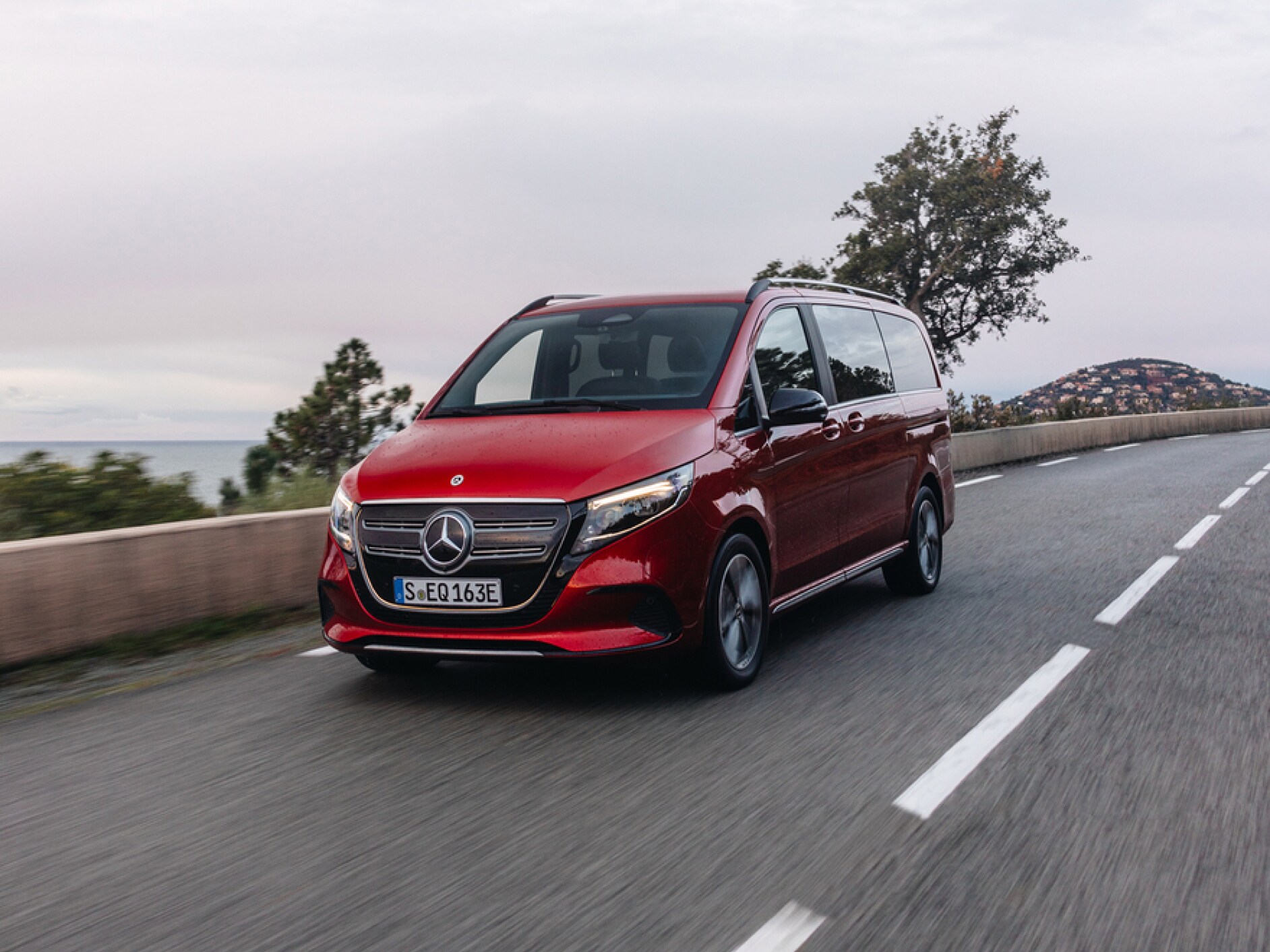 A Mercedes-Benz EQV on a country road.